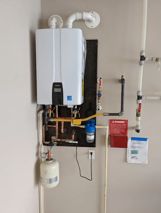 Professional plumber installing copper piping in a Sandwich home